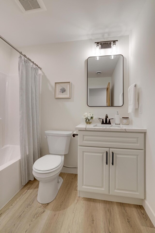 4804 12th Ave S, Minneapolis, MN 55417 - full bath with wood finished floors, toilet, vanity, and shower / bath combo
