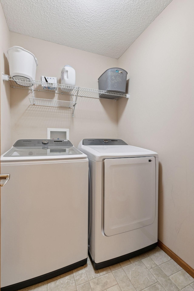 9741 Saint Andrews Dr, Elko New Market, MN 55020 - washroom with independent washer and dryer, a textured ceiling, and baseboards