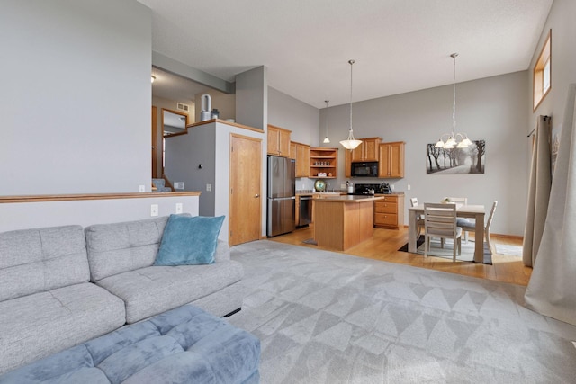 9741 Saint Andrews Dr, Elko New Market, MN 55020 - living area with a chandelier, light carpet, a high ceiling, and light wood finished floors