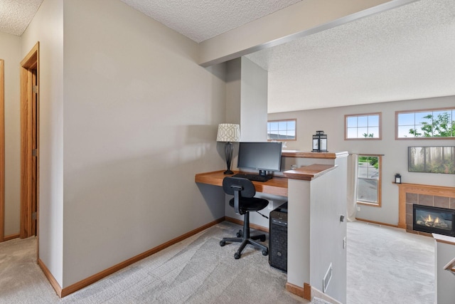 9741 Saint Andrews Dr, Elko New Market, MN 55020 - carpeted office featuring a textured ceiling, baseboards, and a tile fireplace