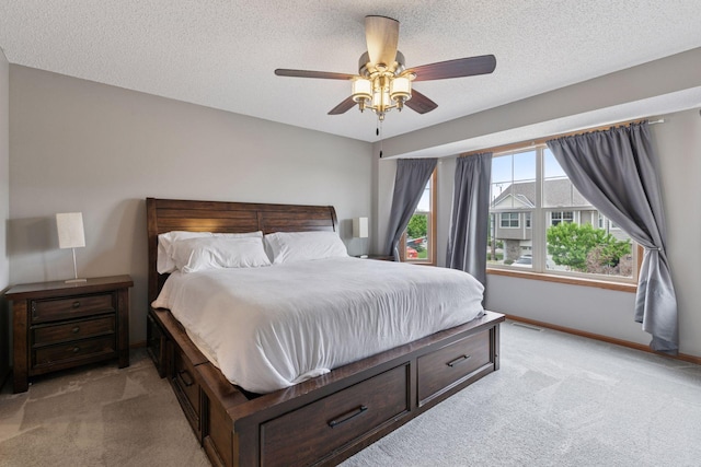 9741 Saint Andrews Dr, Elko New Market, MN 55020 - bedroom with light carpet, baseboards, ceiling fan, and a textured ceiling