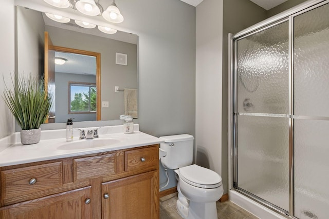 9741 Saint Andrews Dr, Elko New Market, MN 55020 - bathroom featuring toilet, vanity, a stall shower, and tile patterned flooring