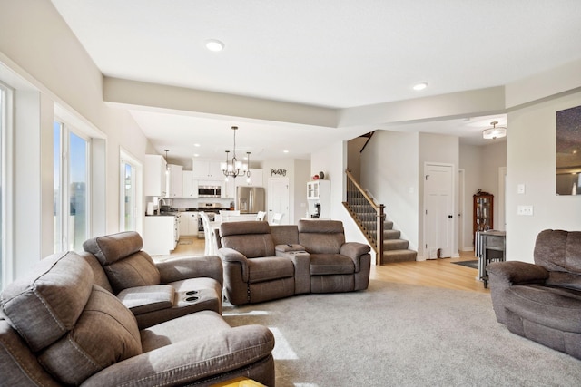 23615 Underclift St NW, Saint Francis, MN 55070 - living area with stairs, light wood-style flooring, a chandelier, and recessed lighting