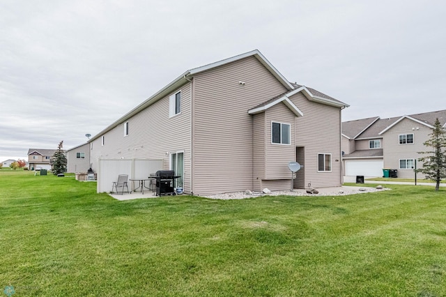 1156 42nd Ave W Unit A, West Fargo, ND 58078 - rear view of property featuring a patio area and a lawn