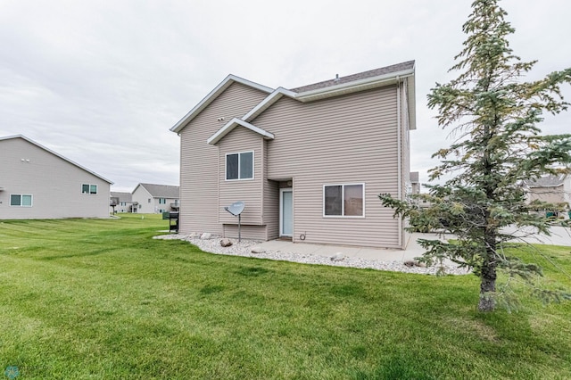 1156 42nd Ave W Unit A, West Fargo, ND 58078 - rear view of house featuring a yard