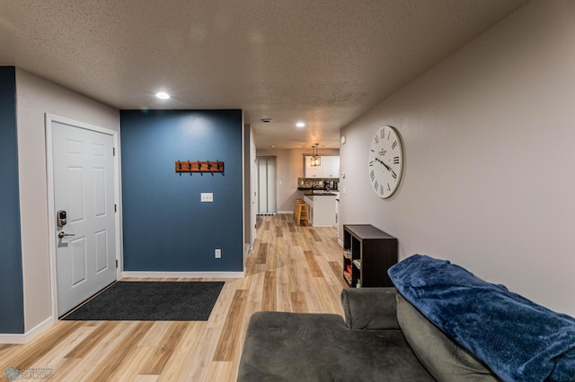 1156 42nd Ave W Unit A, West Fargo, ND 58078 - foyer with light wood-style flooring, baseboards, recessed lighting, and a textured ceiling