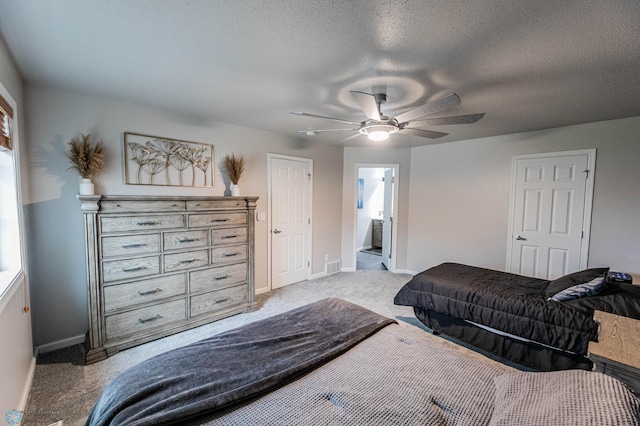 1156 42nd Ave W Unit A, West Fargo, ND 58078 - bedroom with light carpet, baseboards, ceiling fan, a textured ceiling, and ensuite bath
