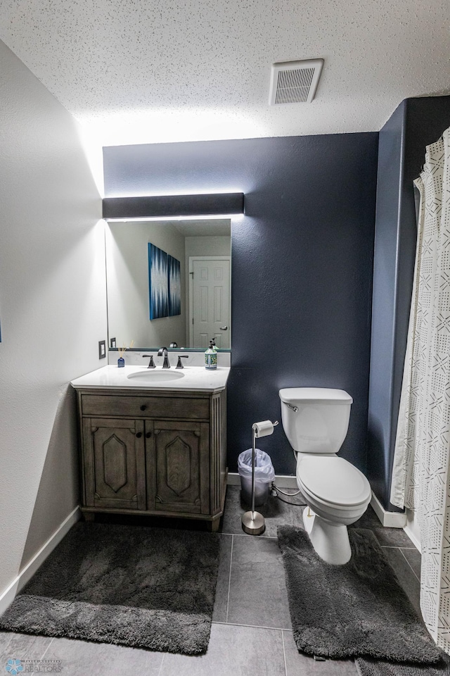 1156 42nd Ave W Unit A, West Fargo, ND 58078 - bathroom with vanity, toilet, baseboards, and a textured ceiling