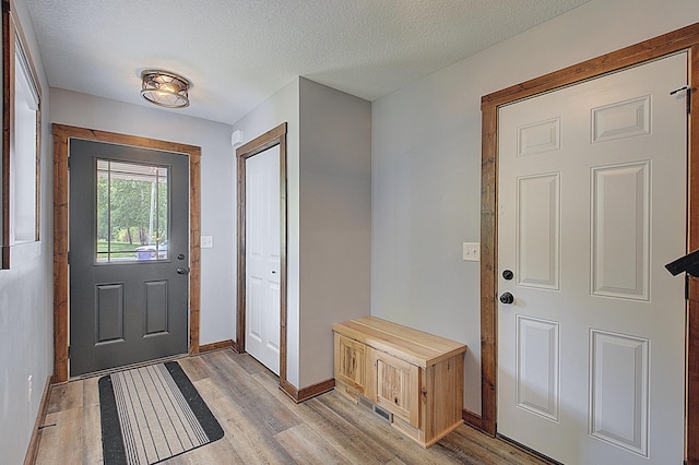 454 Roosevelt Dr, Dresser, WI 54009 - foyer with light wood-type flooring, baseboards, and a textured ceiling