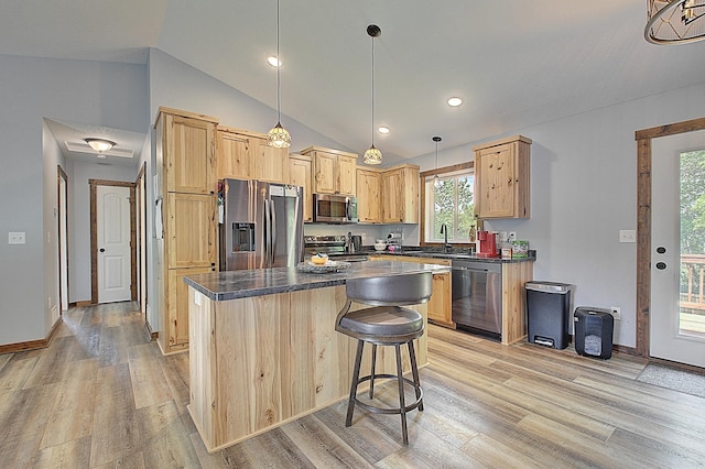 454 Roosevelt Dr, Dresser, WI 54009 - kitchen featuring appliances with stainless steel finishes, dark countertops, lofted ceiling, light wood-style floors, and light brown cabinetry