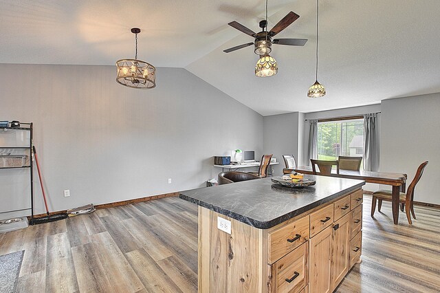454 Roosevelt Dr, Dresser, WI 54009 - kitchen with dark countertops, a ceiling fan, vaulted ceiling, light wood-style floors, and light brown cabinets