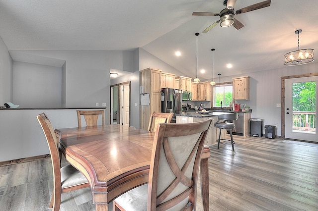 454 Roosevelt Dr, Dresser, WI 54009 - dining space featuring lofted ceiling, a ceiling fan, light wood finished floors, and a chandelier