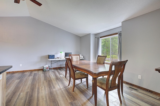 454 Roosevelt Dr, Dresser, WI 54009 - dining area with lofted ceiling, wood finished floors, a ceiling fan, and baseboards