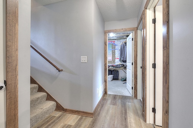 454 Roosevelt Dr, Dresser, WI 54009 - hall featuring wood finished floors, a textured ceiling, and stairs