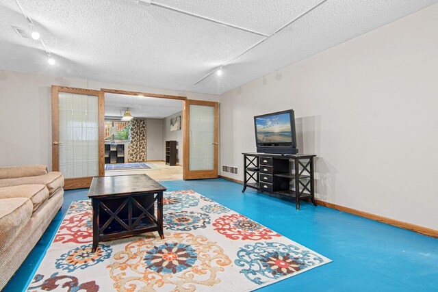 18905 Yalta St NE, East Bethel, MN 55092 - living area featuring rail lighting, baseboards, and a textured ceiling