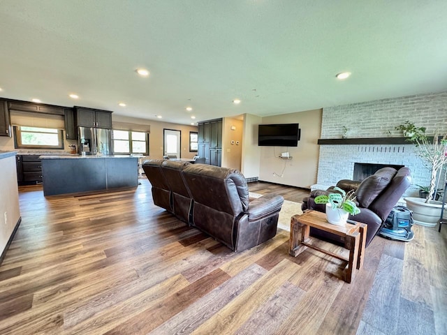 507 5th St NW, Barnesville, MN 56514 - living area with wood finished floors, recessed lighting, a fireplace, and baseboards