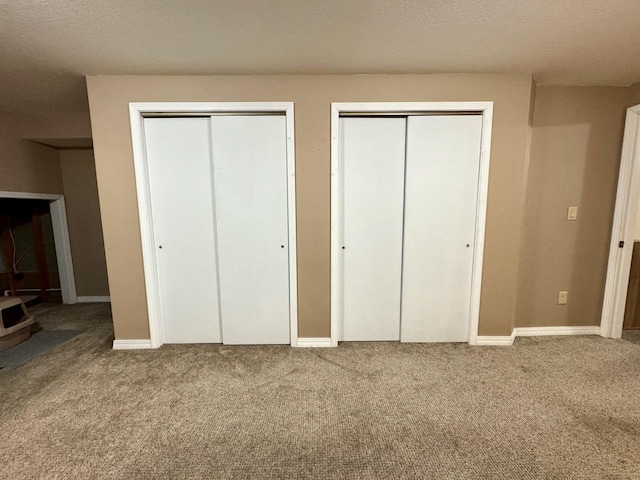 507 5th St NW, Barnesville, MN 56514 - unfurnished bedroom with two closets, carpet floors, and baseboards