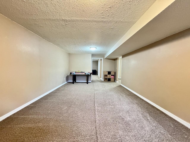 507 5th St NW, Barnesville, MN 56514 - finished below grade area with a textured ceiling, carpet floors, and baseboards
