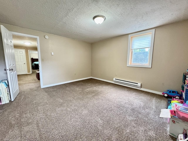 507 5th St NW, Barnesville, MN 56514 - unfurnished room featuring a baseboard heating unit, carpet flooring, baseboards, and a textured ceiling