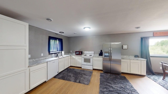 1175 Maben Ave S, Isle, MN 56342 - kitchen with white appliances, light wood finished floors, healthy amount of natural light, and white cabinetry