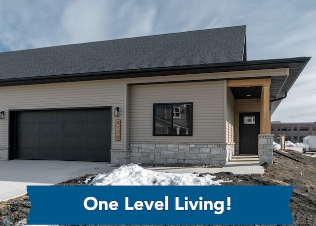 4176 Arthur Dr S, Fargo, ND 58104 - view of front of property featuring stone siding, driveway, and roof with shingles