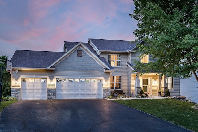 2040 Fountain Ln, Waconia, MN 55387 - craftsman-style house with stone siding, asphalt driveway, an attached garage, and a yard