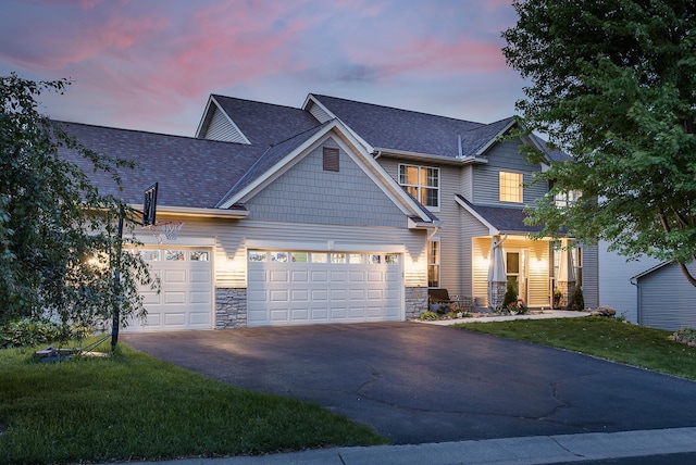 2040 Fountain Ln, Waconia, MN 55387 - craftsman-style house featuring stone siding, driveway, a garage, a shingled roof, and a front yard