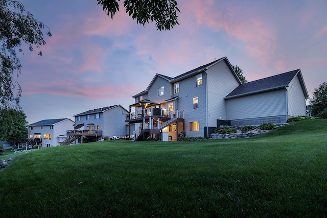 2040 Fountain Ln, Waconia, MN 55387 - back of property with stairway, a deck, and a lawn