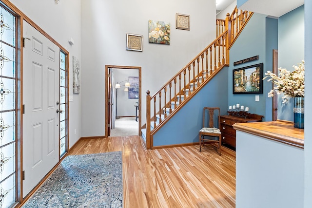 2040 Fountain Ln, Waconia, MN 55387 - entryway featuring wood finished floors, a high ceiling, and stairs