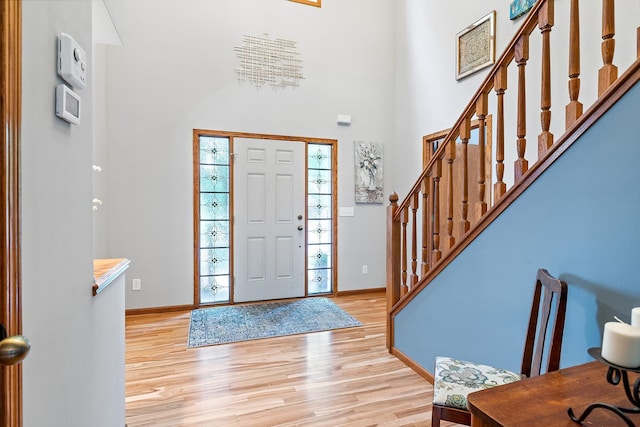 2040 Fountain Ln, Waconia, MN 55387 - entrance foyer featuring stairs, light wood-style floors, and a high ceiling