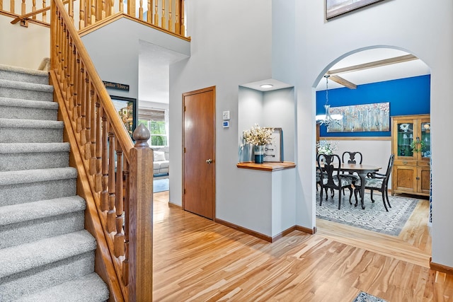2040 Fountain Ln, Waconia, MN 55387 - entrance foyer with a high ceiling, wood finished floors, arched walkways, stairs, and a chandelier