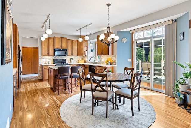 2040 Fountain Ln, Waconia, MN 55387 - dining room featuring light wood finished floors and a chandelier