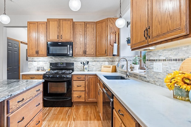 2040 Fountain Ln, Waconia, MN 55387 - kitchen featuring black appliances, brown cabinets, backsplash, and pendant lighting