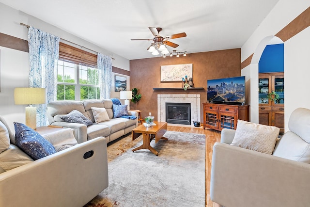 2040 Fountain Ln, Waconia, MN 55387 - living area featuring a ceiling fan, wood finished floors, and a fireplace with flush hearth