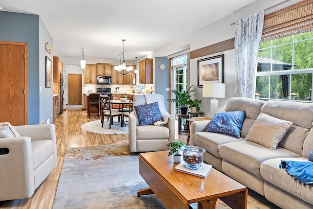 2040 Fountain Ln, Waconia, MN 55387 - living room featuring a chandelier and light wood finished floors