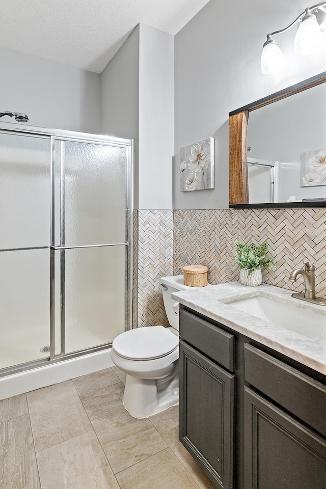 2040 Fountain Ln, Waconia, MN 55387 - full bathroom featuring vanity, a stall shower, and tile walls