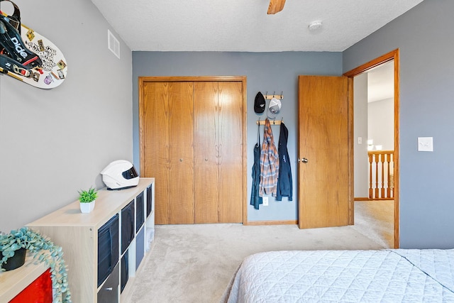 2040 Fountain Ln, Waconia, MN 55387 - bedroom with carpet flooring, a closet, a textured ceiling, and ceiling fan