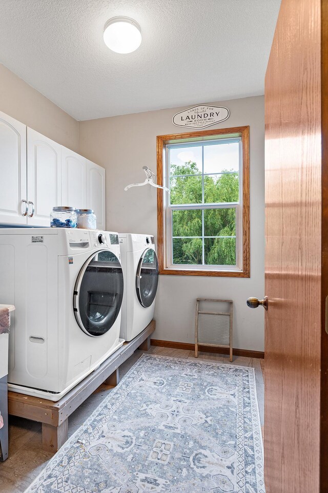 2040 Fountain Ln, Waconia, MN 55387 - laundry area with cabinet space, washer and clothes dryer, and a textured ceiling