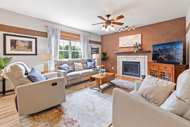 2040 Fountain Ln, Waconia, MN 55387 - living area with wood finished floors, a tiled fireplace, ceiling fan, and rail lighting
