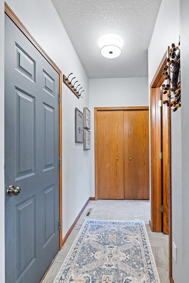 2040 Fountain Ln, Waconia, MN 55387 - doorway to outside featuring a textured ceiling and baseboards