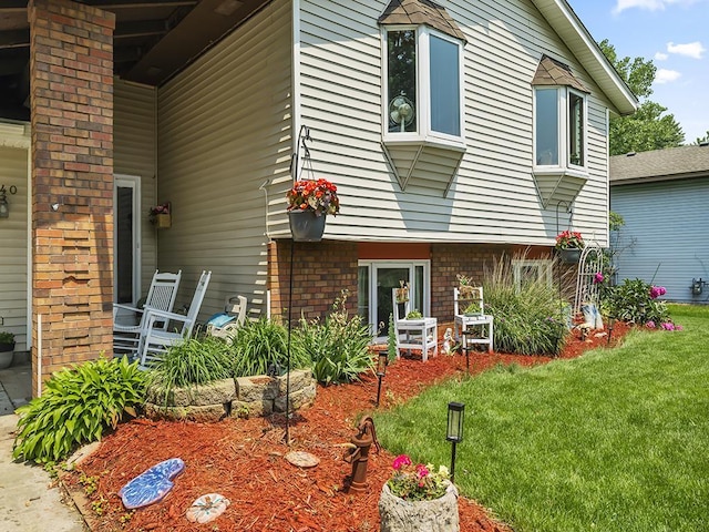 10740 99th Pl N, Maple Grove, MN 55369 - view of side of property featuring brick siding and a yard