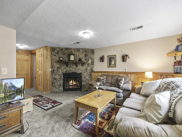 10740 99th Pl N, Maple Grove, MN 55369 - living room featuring carpet floors, a fireplace, a textured ceiling, a wainscoted wall, and wooden walls