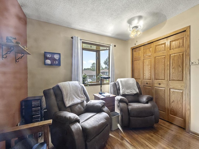 10740 99th Pl N, Maple Grove, MN 55369 - living area with wood finished floors, a textured ceiling, and a ceiling fan