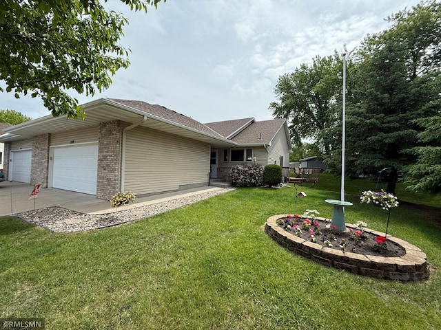 1508 Terrance Cir NE, New Prague, MN 56071 - view of home's exterior with a lawn, brick siding, a garage, concrete driveway, and a shingled roof