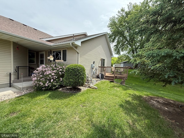 1508 Terrance Cir NE, New Prague, MN 56071 - view of side of property with a yard, a deck, and a shingled roof
