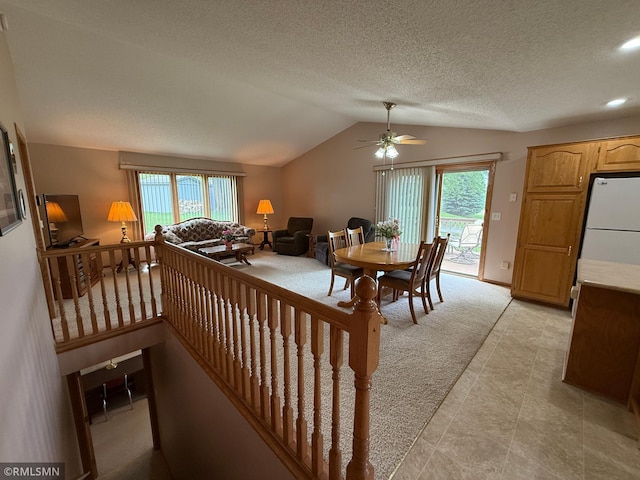 1508 Terrance Cir NE, New Prague, MN 56071 - dining space with lofted ceiling, light carpet, a ceiling fan, healthy amount of natural light, and a textured ceiling