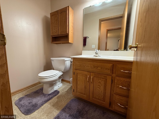 1508 Terrance Cir NE, New Prague, MN 56071 - half bath featuring vanity, toilet, baseboards, and tile patterned floors