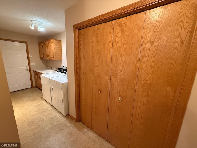 1508 Terrance Cir NE, New Prague, MN 56071 - laundry room with cabinet space, washer and dryer, and a textured ceiling