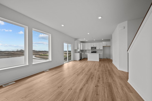 7150 Large Ave NE, Otsego, MN 55301 - unfurnished living room featuring recessed lighting, light wood-style floors, and baseboards