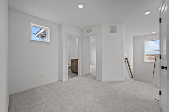 7150 Large Ave NE, Otsego, MN 55301 - unfurnished bedroom featuring multiple windows, carpet flooring, recessed lighting, baseboards, and ensuite bathroom